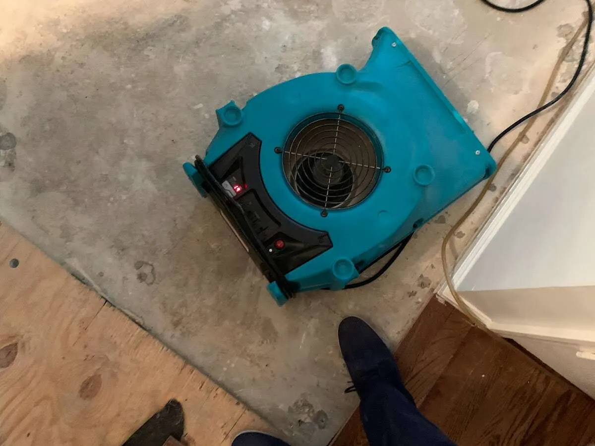 Air mover drying subfloor during Commercial Water Damage Restoration in Dumas